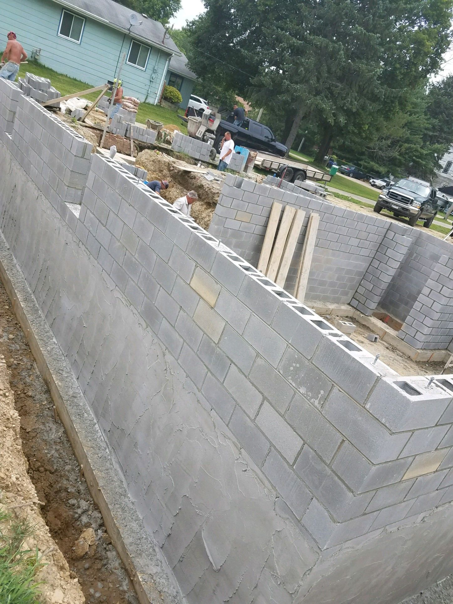 Block foundation walls rising from the footings of a new house.